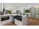 Open kitchen with black farmhouse sink, modern appliances, island seating, and wine rack feature at 8419 E Rancho Vista Dr, Scottsdale, AZ 85251
