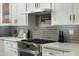 Bright kitchen with stainless steel oven, sleek gray backsplash, and ample counter space at 8419 E Rancho Vista Dr, Scottsdale, AZ 85251