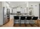 Open concept kitchen features an island, white cabinetry and stainless steel appliances at 8419 E Rancho Vista Dr, Scottsdale, AZ 85251