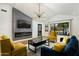 Stylish living room with a modern fireplace, large window, and elegant furnishings at 8419 E Rancho Vista Dr, Scottsdale, AZ 85251