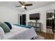 Bedroom with ceiling fan, TV, decorative cabinet, and ensuite bathroom at 8419 E Rancho Vista Dr, Scottsdale, AZ 85251