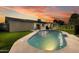 Inviting pool surrounded by lush landscaping and a charming patio area at sunset at 8419 E Rancho Vista Dr, Scottsdale, AZ 85251