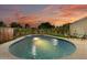 Inviting pool surrounded by lush landscaping and a charming patio area at sunset at 8419 E Rancho Vista Dr, Scottsdale, AZ 85251