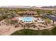 Aerial view of a resort-style community pool and clubhouse with well-maintained landscaping and desert surroundings at 8804 E Ivy St, Mesa, AZ 85207