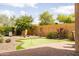 A lovely backyard featuring a putting green, beautiful flowers and green trees at 8804 E Ivy St, Mesa, AZ 85207
