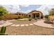 Private backyard with a putting green, covered patio, and low-maintenance desert landscaping at 8804 E Ivy St, Mesa, AZ 85207
