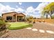 Beautiful backyard featuring a putting green, patio area, and a charming fire pit area at 8804 E Ivy St, Mesa, AZ 85207