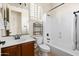 Bathroom featuring a tub and shower combination, toilet, vanity, sink, and large mirror at 8804 E Ivy St, Mesa, AZ 85207
