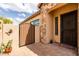 Charming entrance with a brick-paved courtyard, stone accents, a gated entry and drought-resistant landscaping at 8804 E Ivy St, Mesa, AZ 85207