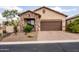 Charming home featuring a stone facade, a two-car garage, and desert landscaping for low maintenance at 8804 E Ivy St, Mesa, AZ 85207
