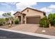 Charming home with a desert landscape, stone accents, paver driveway, and a two-car garage in a serene setting at 8804 E Ivy St, Mesa, AZ 85207