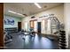 The fitness center includes a variety of exercise equipment, TV, and motivational wall art for a complete workout experience at 8804 E Ivy St, Mesa, AZ 85207