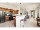 Open kitchen with modern appliances, breakfast bar, and tile flooring, perfect for entertaining at 8804 E Ivy St, Mesa, AZ 85207