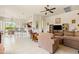 Inviting living room features tile floors, ceiling fan, and a breakfast bar overlooking an open kitchen at 8804 E Ivy St, Mesa, AZ 85207