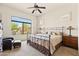 Comfortable main bedroom with a large window and a ceiling fan at 8804 E Ivy St, Mesa, AZ 85207