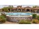 Relaxing community pool with a fountain and a view of the clubhouse perfect for a resort-style living experience at 8804 E Ivy St, Mesa, AZ 85207