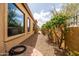 Landscaped side yard with lush greenery and a brick pathway along the house at 8804 E Ivy St, Mesa, AZ 85207