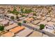 Aerial view shows a vibrant residential neighborhood with tree-lined streets and well-maintained homes and yards at 9110 W Palm Ln, Phoenix, AZ 85037