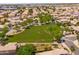Aerial view of a community featuring a lush green common area and well-maintained residential homes at 9110 W Palm Ln, Phoenix, AZ 85037