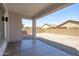 Covered back patio with concrete flooring offering an outdoor space with views of the surrounding yard and neighborhood at 9110 W Palm Ln, Phoenix, AZ 85037