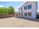 Large backyard featuring fresh gravel, a covered patio, and mature landscaping at 9110 W Palm Ln, Phoenix, AZ 85037