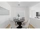 Bright dining area featuring a modern table, comfortable chairs, and a sunlit window at 9110 W Palm Ln, Phoenix, AZ 85037