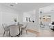 Elegant dining area with a modern table, comfortable seating, and open view into a well-decorated living space at 9110 W Palm Ln, Phoenix, AZ 85037