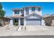 Charming two-story home featuring a well-manicured front yard and a two-car garage at 9110 W Palm Ln, Phoenix, AZ 85037