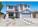 Charming two-story home with a well-maintained front yard, desert landscaping, and inviting curb appeal at 9110 W Palm Ln, Phoenix, AZ 85037