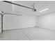 Spacious, clean garage with epoxy flooring, ample lighting, and an automatic door opener for convenience at 9110 W Palm Ln, Phoenix, AZ 85037