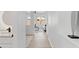Bright hallway featuring modern decor, hardwood floors, and a glimpse into a stylishly decorated living room at 9110 W Palm Ln, Phoenix, AZ 85037