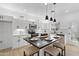 Bright kitchen with white cabinets, stainless steel appliances, a marble countertop island and modern pendant lighting at 9110 W Palm Ln, Phoenix, AZ 85037