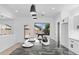 Modern kitchen features a black marble island, sleek white cabinets, and contemporary pendant lighting at 9110 W Palm Ln, Phoenix, AZ 85037