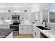 Well-lit kitchen with modern appliances, sleek countertops, ample cabinet space, and stylish lighting fixtures at 9110 W Palm Ln, Phoenix, AZ 85037