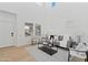 Bright living room with vaulted ceilings, neutral decor, and large windows offering ample natural light at 9110 W Palm Ln, Phoenix, AZ 85037