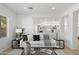 Cozy living room showcases modern furniture, a neutral palette, and bright, natural light through the large windows at 9110 W Palm Ln, Phoenix, AZ 85037