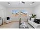 Light-filled living room boasts updated furniture, neutral tones, large windows, and bright light at 9110 W Palm Ln, Phoenix, AZ 85037