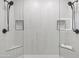 Modern shower showcasing a glass enclosure, dual shower heads and built in soap niches at 9110 W Palm Ln, Phoenix, AZ 85037