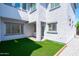 A cozy side yard with artificial turf and gravel accents, providing a low-maintenance and aesthetically pleasing outdoor area at 9110 W Palm Ln, Phoenix, AZ 85037