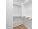 Walk-in closet with wood-look floors and shelving at 9110 W Palm Ln, Phoenix, AZ 85037