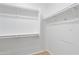 Walk-in closet featuring wood-look floors and shelving at 9110 W Palm Ln, Phoenix, AZ 85037