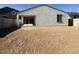 Spacious backyard featuring a blank canvas with sliding glass doors leading to the patio at 9547 W Parkway Dr, Tolleson, AZ 85353