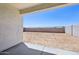 View of a large backyard with block fencing, desert landscaping, and a covered patio at 9547 W Parkway Dr, Tolleson, AZ 85353
