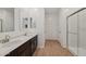 Bathroom with wood look flooring, vanity with sink, and walk-in shower at 9547 W Parkway Dr, Tolleson, AZ 85353