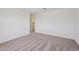 Bedroom with a window overlooking trees, light walls, and carpet flooring at 9547 W Parkway Dr, Tolleson, AZ 85353