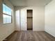 This is a cozy bedroom with plush carpeting, a window for natural light, and a closet for storage at 9547 W Parkway Dr, Tolleson, AZ 85353