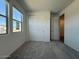 Bright bedroom with closet and large windows offering plenty of natural light at 9547 W Parkway Dr, Tolleson, AZ 85353
