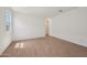 Spacious bedroom with a window, light walls, and wood look flooring at 9547 W Parkway Dr, Tolleson, AZ 85353