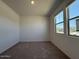Well-lit bedroom featuring carpeted floors and a large window for ample natural light at 9547 W Parkway Dr, Tolleson, AZ 85353