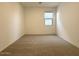 Spacious bedroom featuring neutral carpet and a window for natural light at 9547 W Parkway Dr, Tolleson, AZ 85353